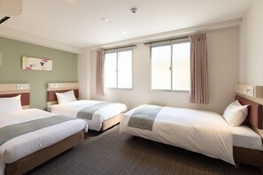 A hotel room with two single beds, a large window with curtains, a wall-mounted artwork, and a carpeted floor.