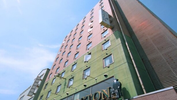 A multi-story hotel with a prominent 'BOSTON' sign on the facade. - Business Hotel Boston (Oita)