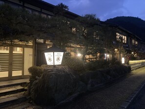 A traditional Japanese building with a stone lantern and signage. - Ryoso Chatani (Kyoto)
