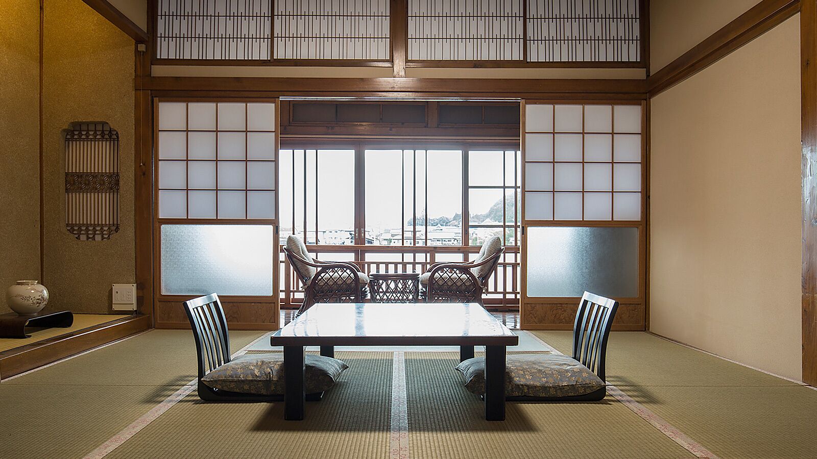 A traditional Japanese room with tatami flooring, a low table, and shoji screens.