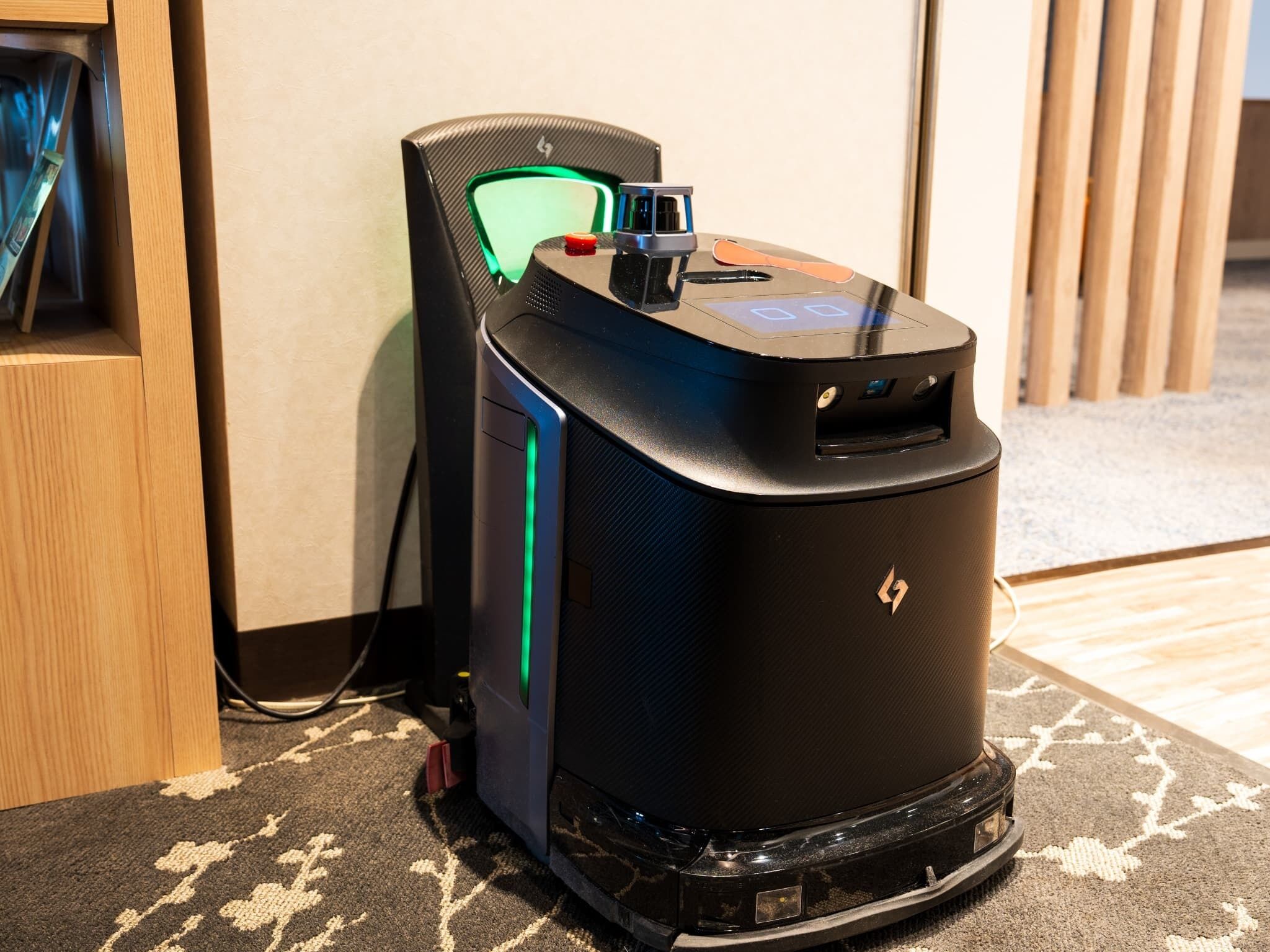 A black gaming PC with a transparent side panel, a green light, and a USB port on top.
