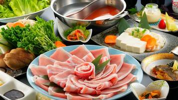 A variety of food items including sliced meats, vegetables, and a hot pot setup.