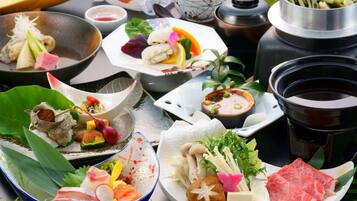 A variety of dishes and hot pot setup, likely for a dining experience.