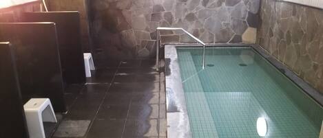 A public restroom with a pool area.