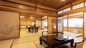 A traditional Japanese room with tatami flooring, a low wooden table, and sliding doors.