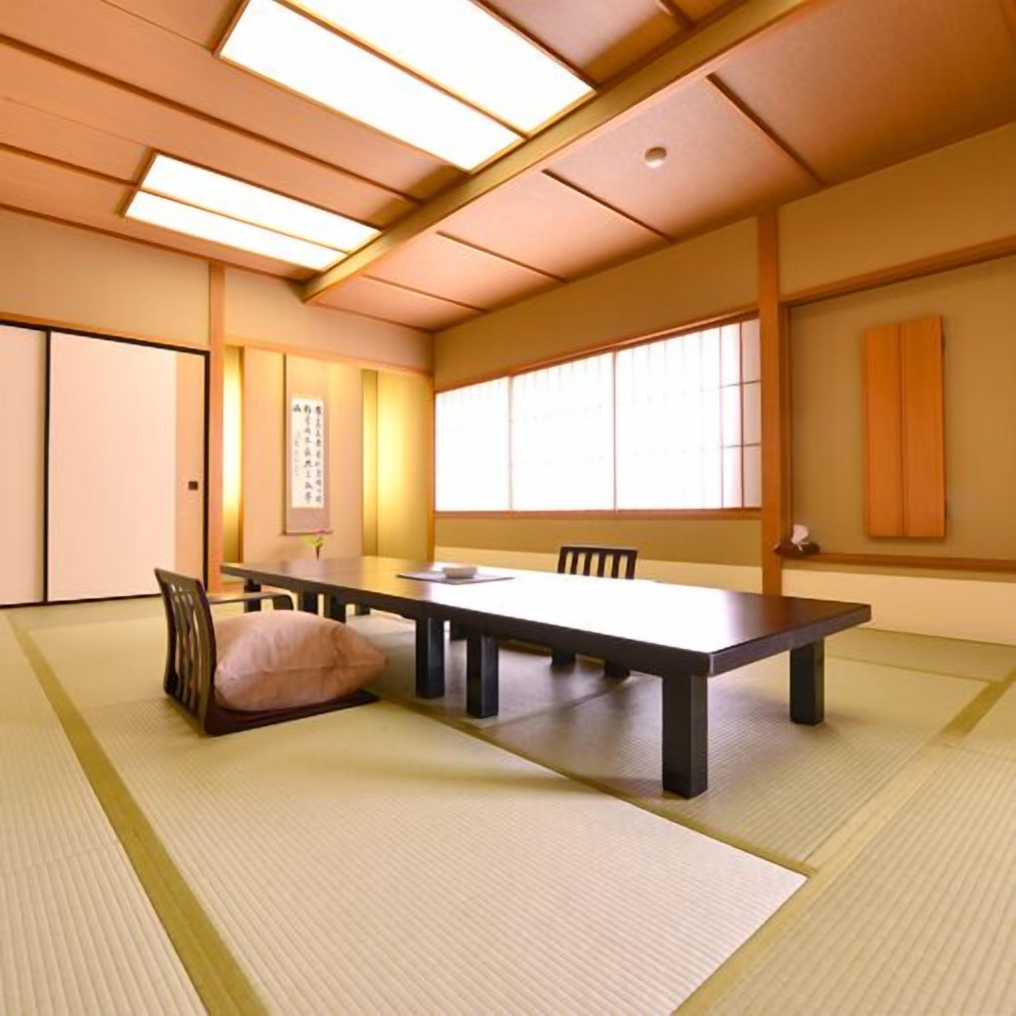 A traditional Japanese-style room with tatami flooring, a low table, and sliding doors.