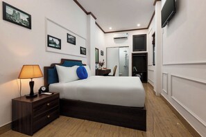 A hotel room with a bed, bedside table, lamp, and wall-mounted TV. - The Ambery Boutique Hotel & Travel (Hanoi)