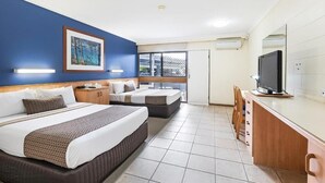 A hotel room with two beds, a TV, a desk, and a window with a view. - Cannonvale Reef Gateway Hotel (Cannonvale)