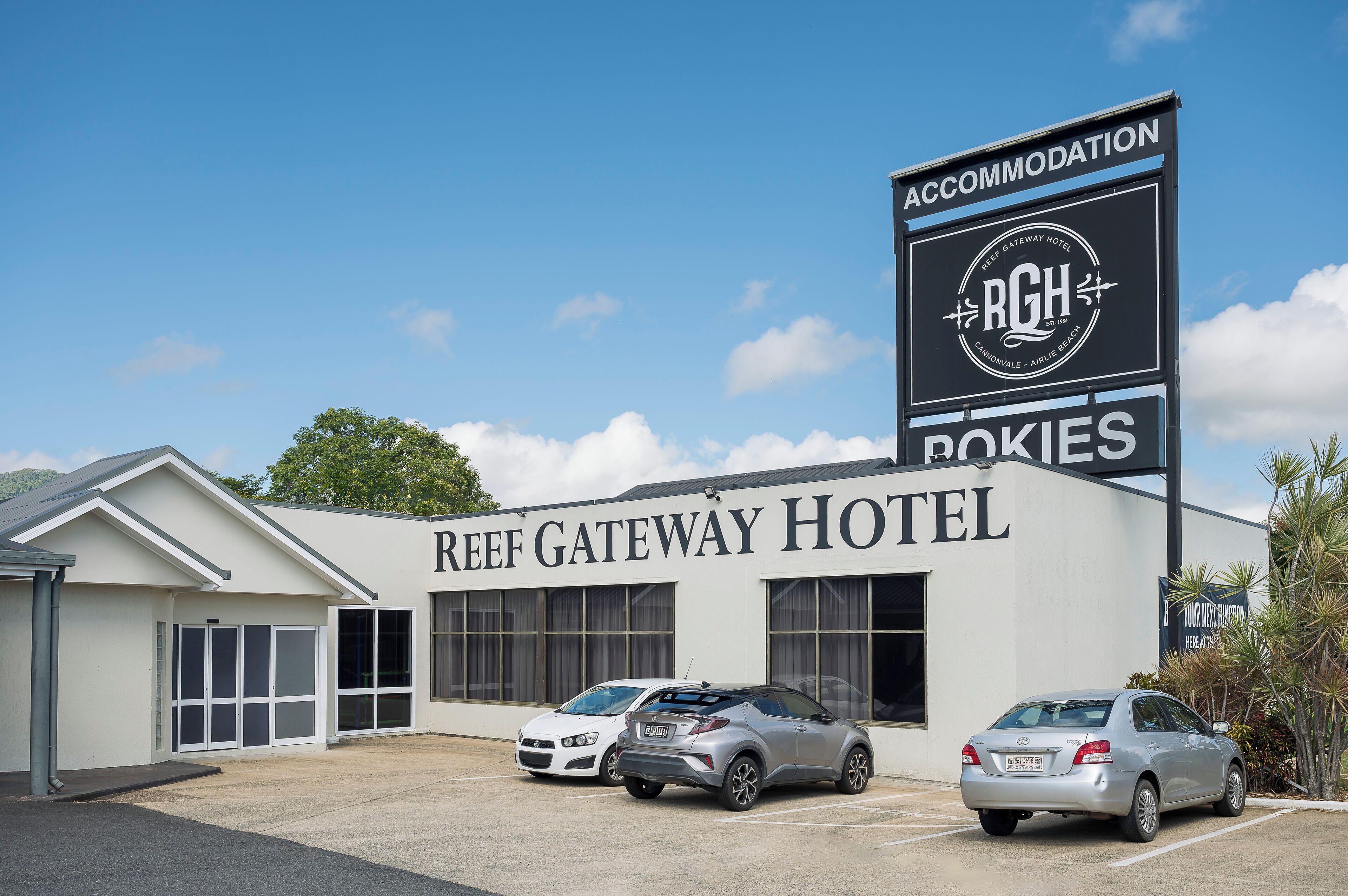 The Reef Gateway Hotel with a large sign indicating accommodation.