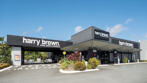 A Harry Brown Wine, Beer & Spirits store with a modern design, featuring a clear entrance and a signboard. - Cannonvale Reef Gateway Hotel (Cannonvale)