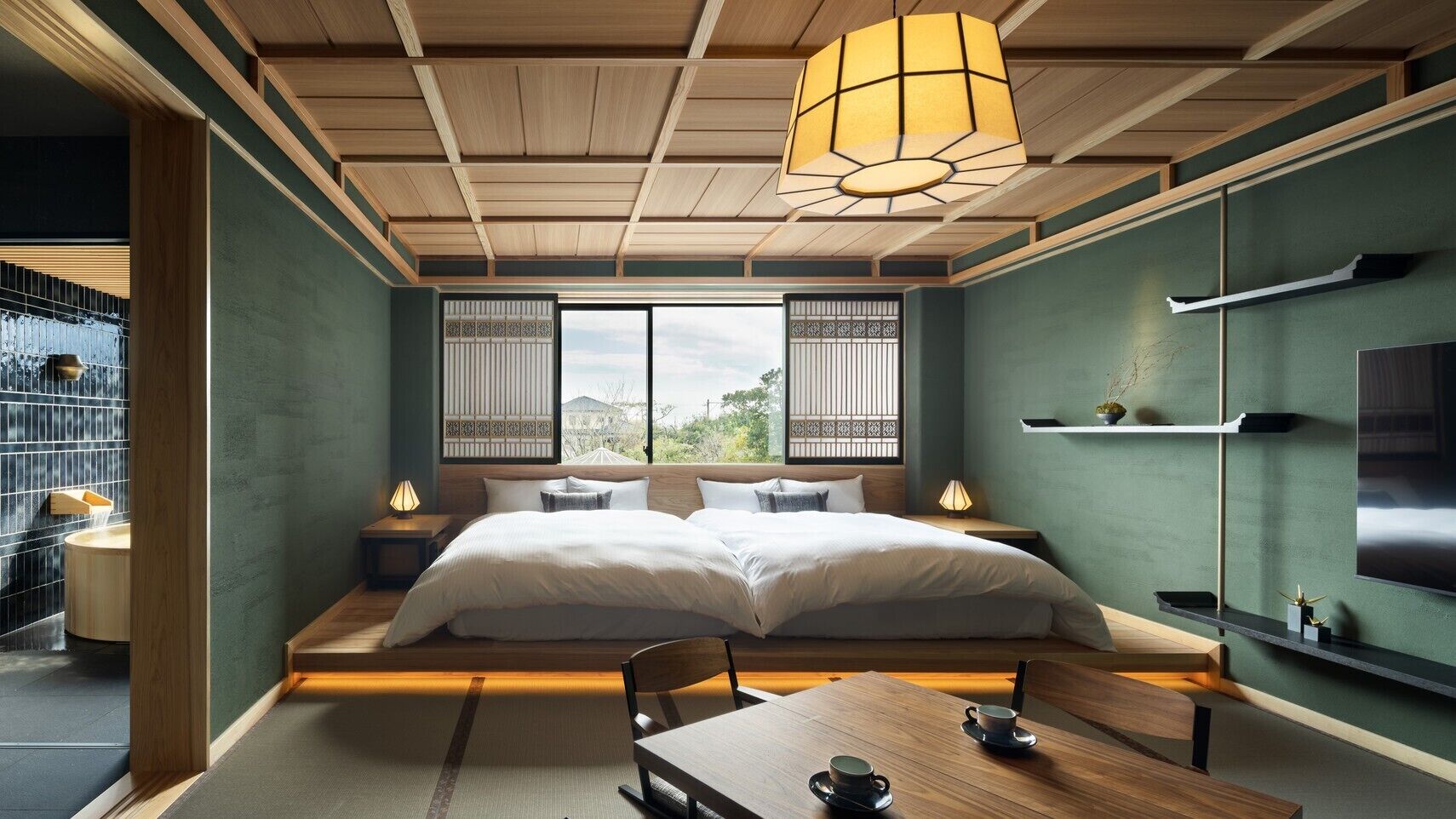 A modern bedroom with a wooden ceiling, a large bed, bedside tables, a TV, and a view through the window.