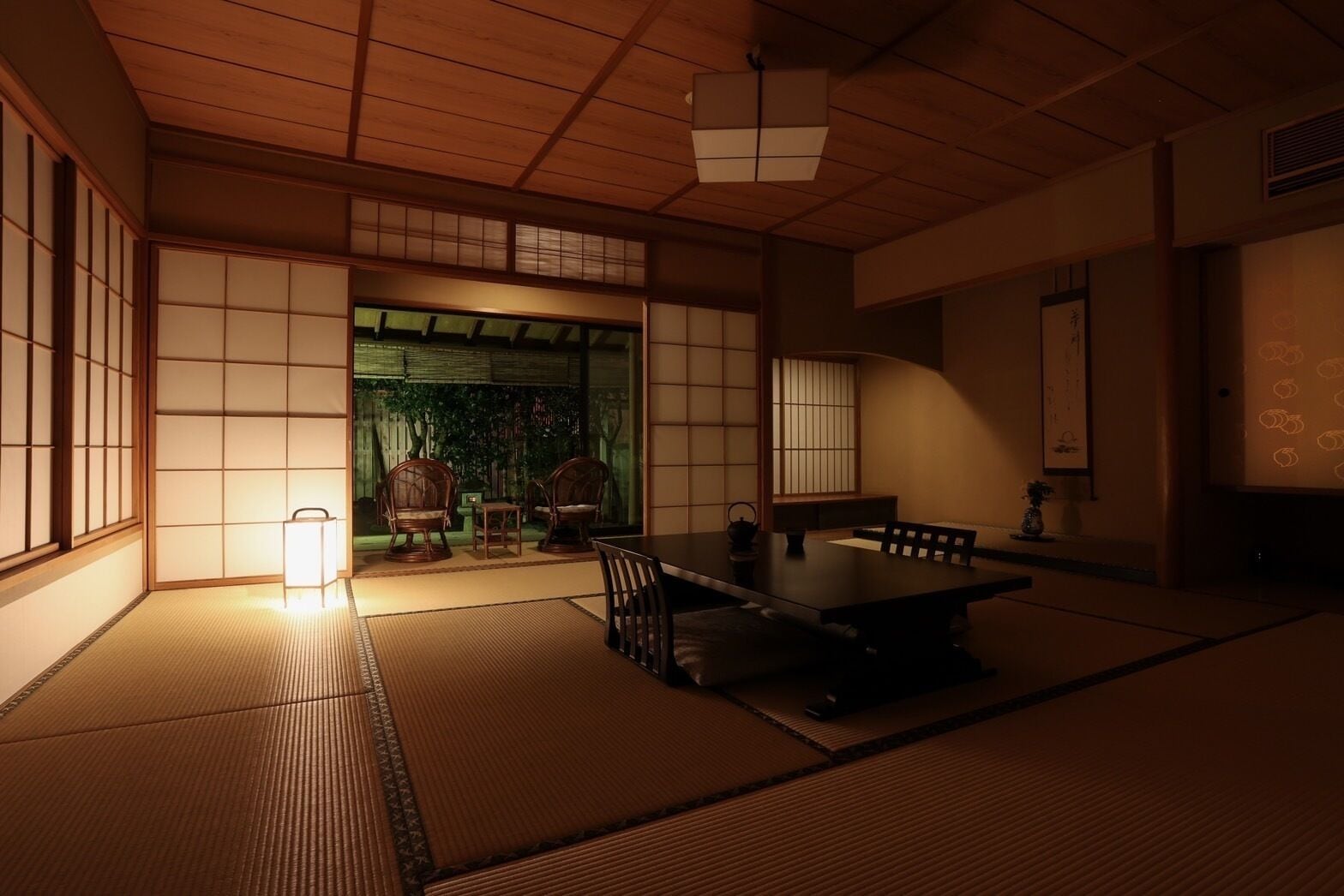 A traditional Japanese room with tatami flooring, a low table, and sliding doors.