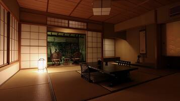A traditional Japanese room with tatami flooring, a low table, and sliding doors.