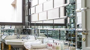 A modern bathroom with two sinks, a marble countertop, and a large mirror.