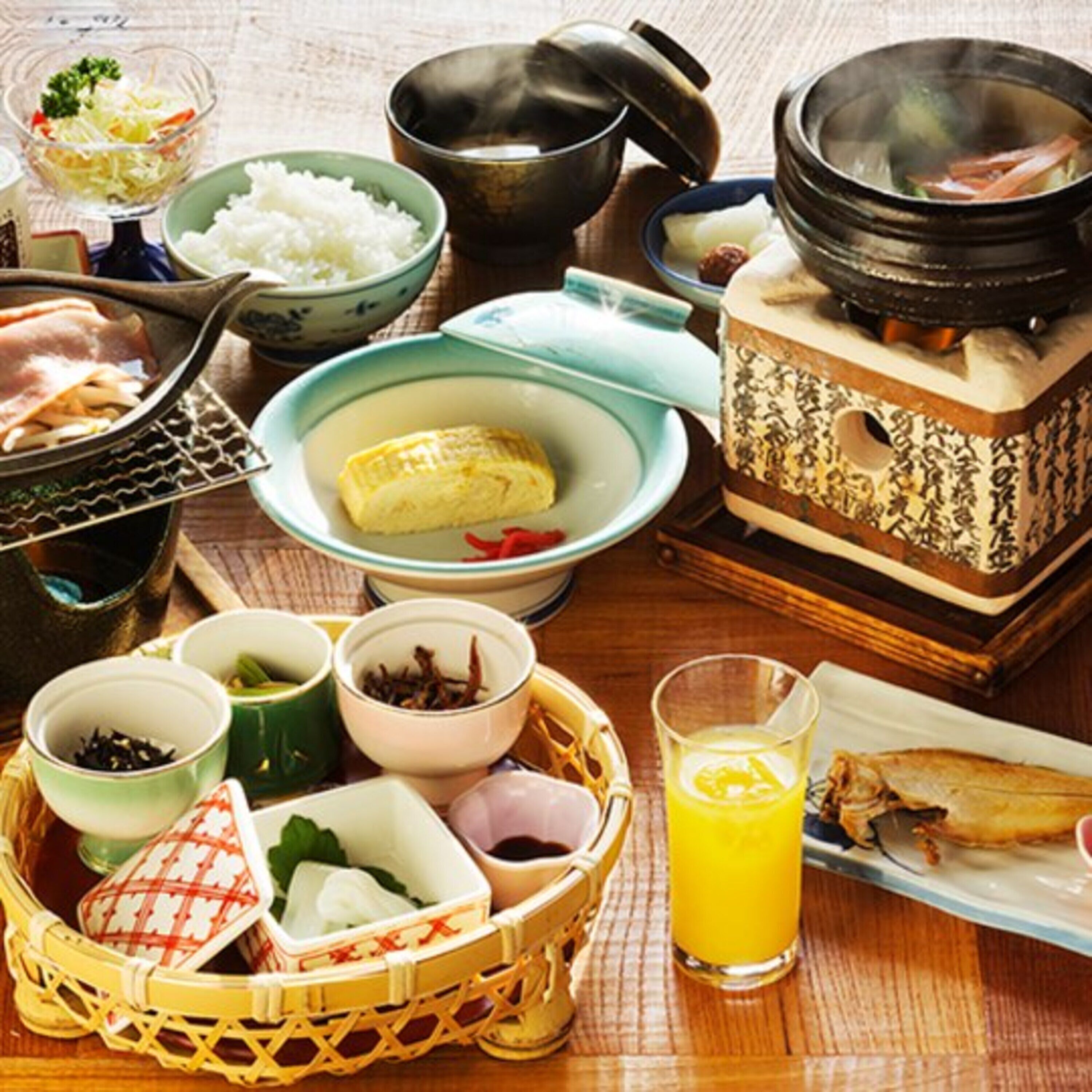 A traditional Japanese meal setup with various dishes and a hot pot.