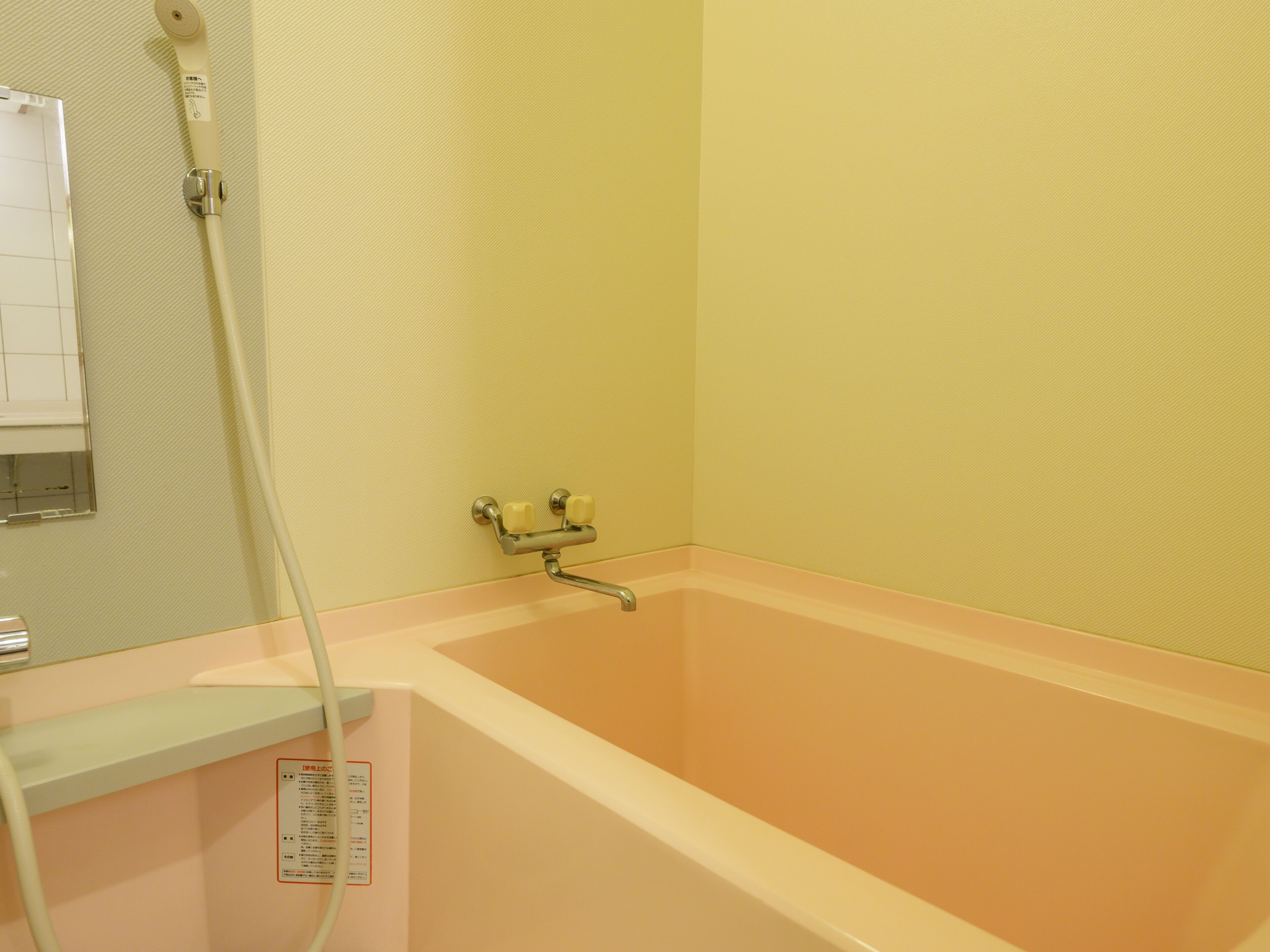 A bathroom with a bathtub, a shower, and a toilet.