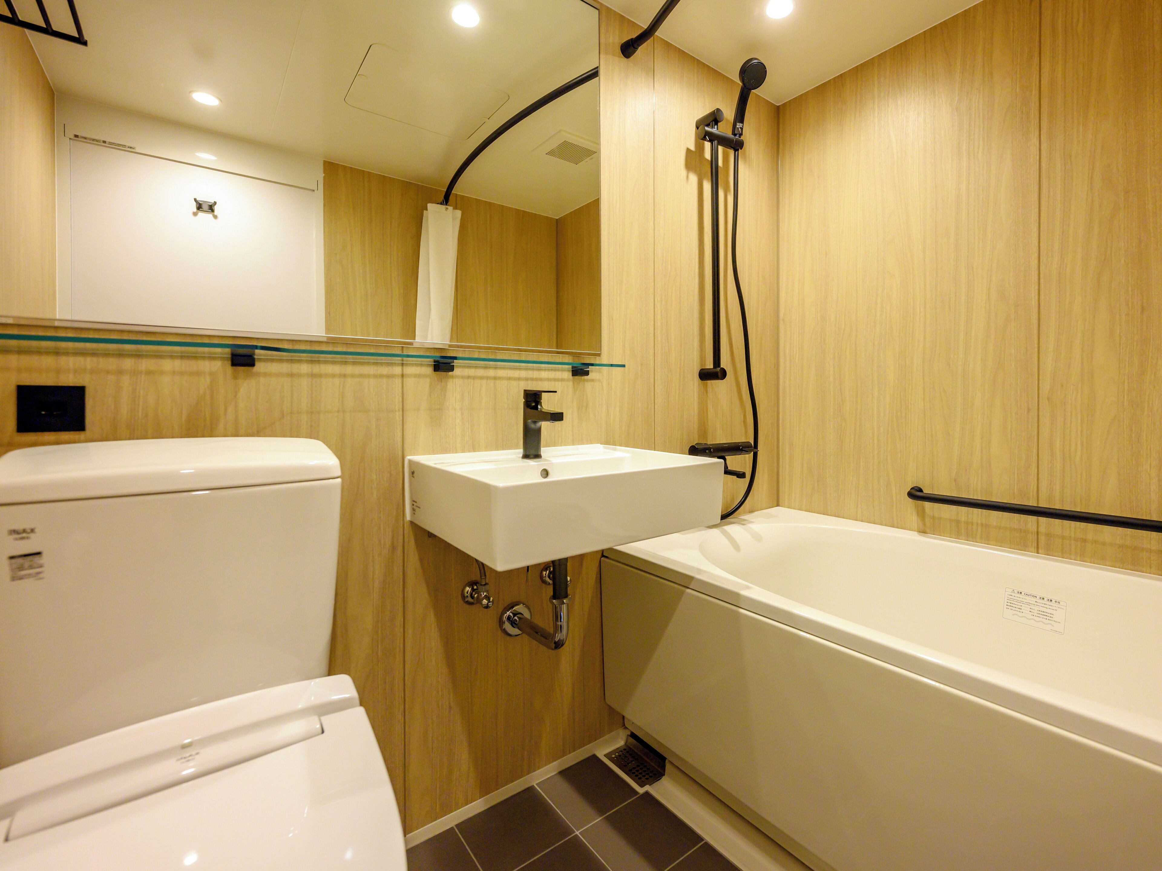 A bathroom with a toilet, sink, and bathtub.