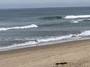 A beach with waves approaching the shore.