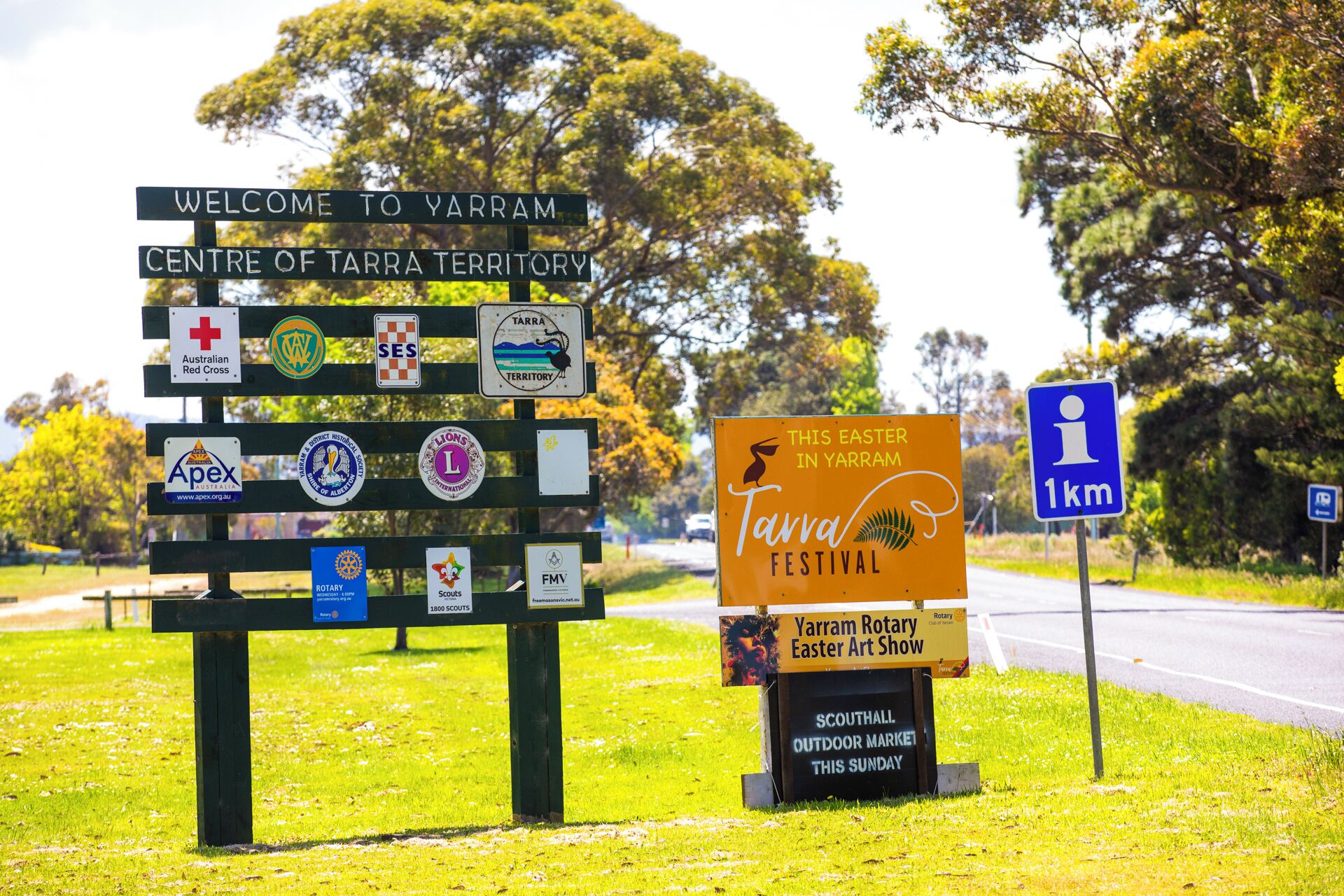 A welcome sign to Yarram with various logos and a sign for the Tarran Festival.