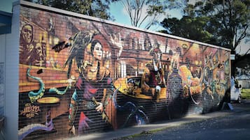 Un mural en una pared de ladrillo con diseños abstractos y coloridos.