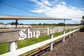 A wooden fence with the sign "Shop Inn Hotel" indicating a hotel establishment. - Ship Motel Yarram (Yarram)