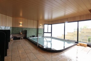 A swimming pool with a glass barrier, wooden ceiling, and large windows. - Miyahama Onsen Miyahama Grand Hotel (Hatsukaichi)