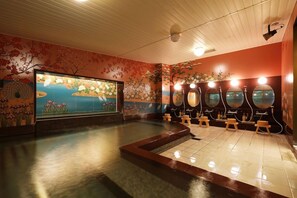 Un área de spa con un amplio mural, varios jacuzzis y piso de baldosas.