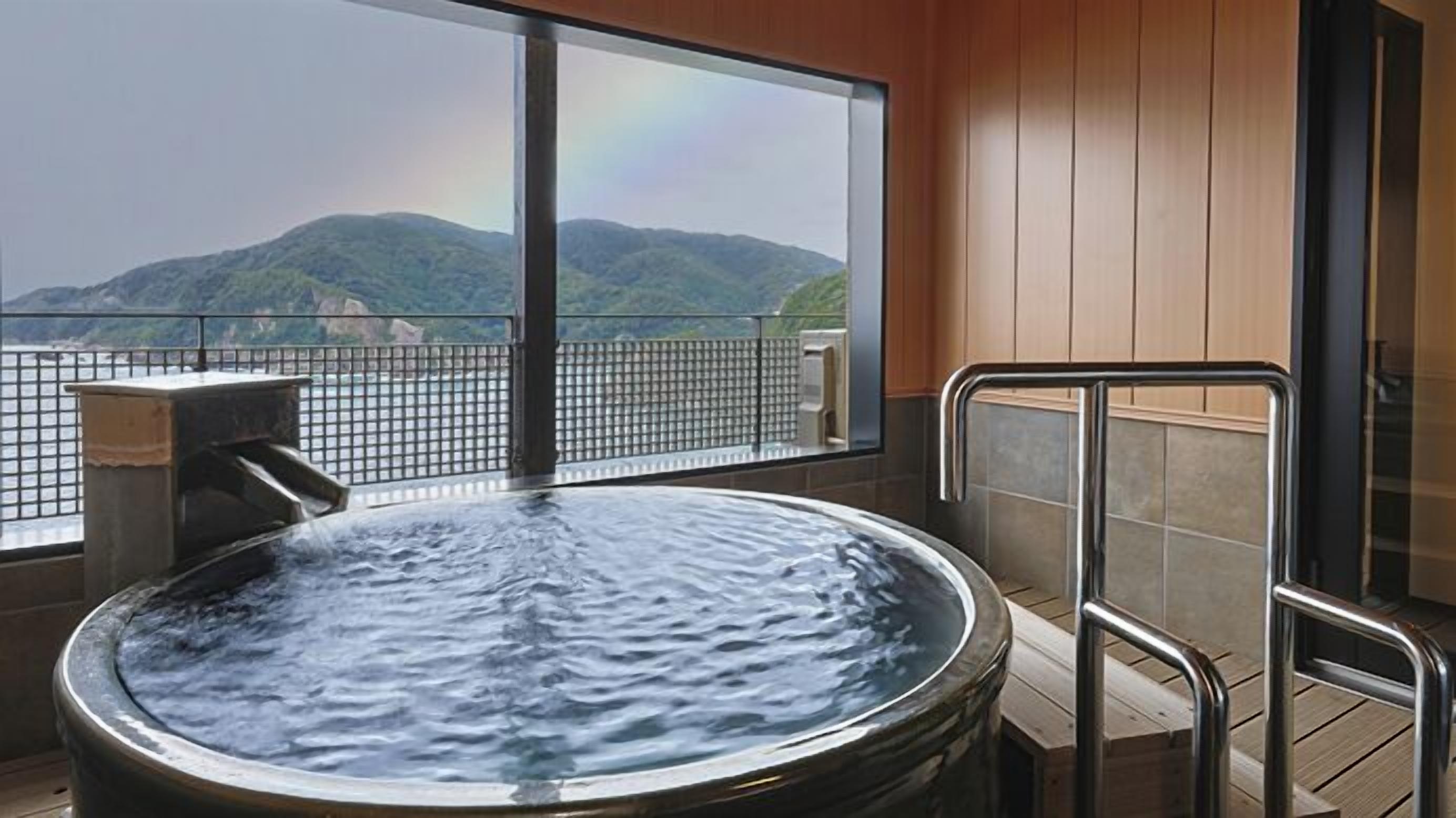 A hot tub with a view of mountains.