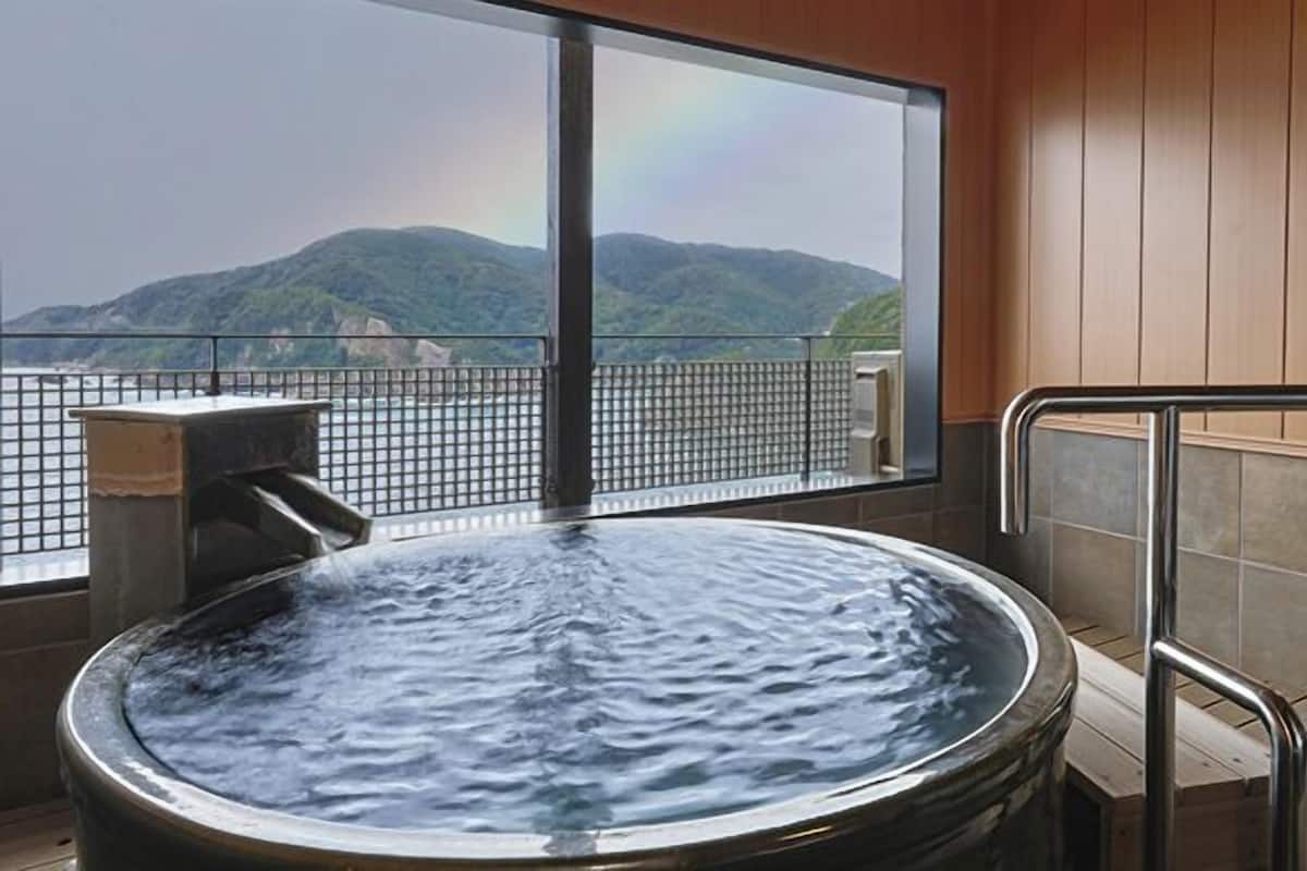 A hot tub with a view of mountains.