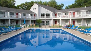 Relax by the pool surrounded by lush greenery and enjoy the tranquil atmosphere.
