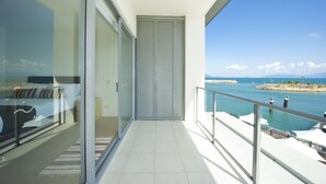 A balcony with a view of a calm sea and distant mountains. - Blue On Blue Superior Studio Room 1361 (Nelly Bay)