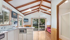 A kitchen with wooden beams, a microwave, and a sink. - Bellarine Bayside Holiday Parks (Portarlington)
