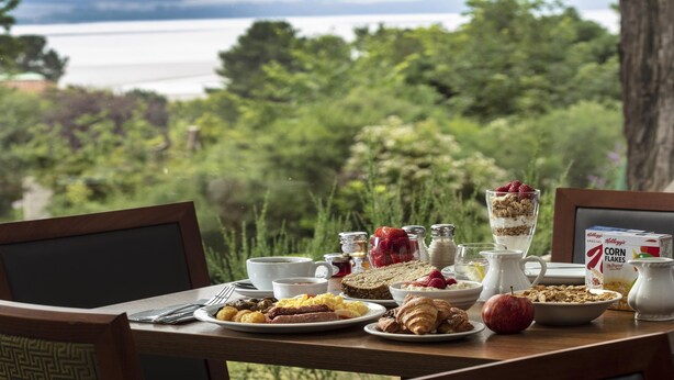 A breakfast table with various food items and a box of Kellogg's Special K Corn Flakes cereal.
