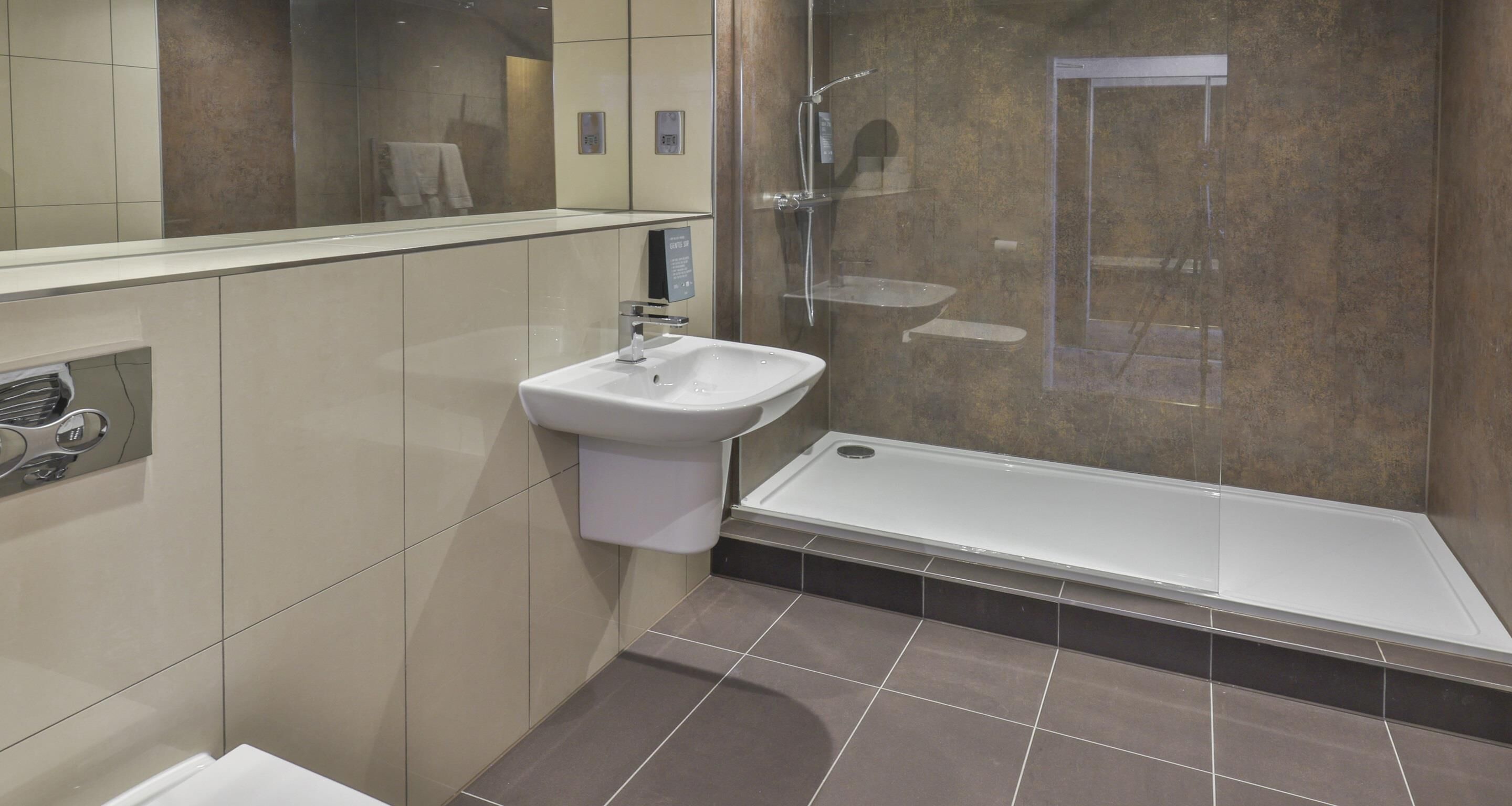 A modern bathroom with a sink, shower, and bathtub.