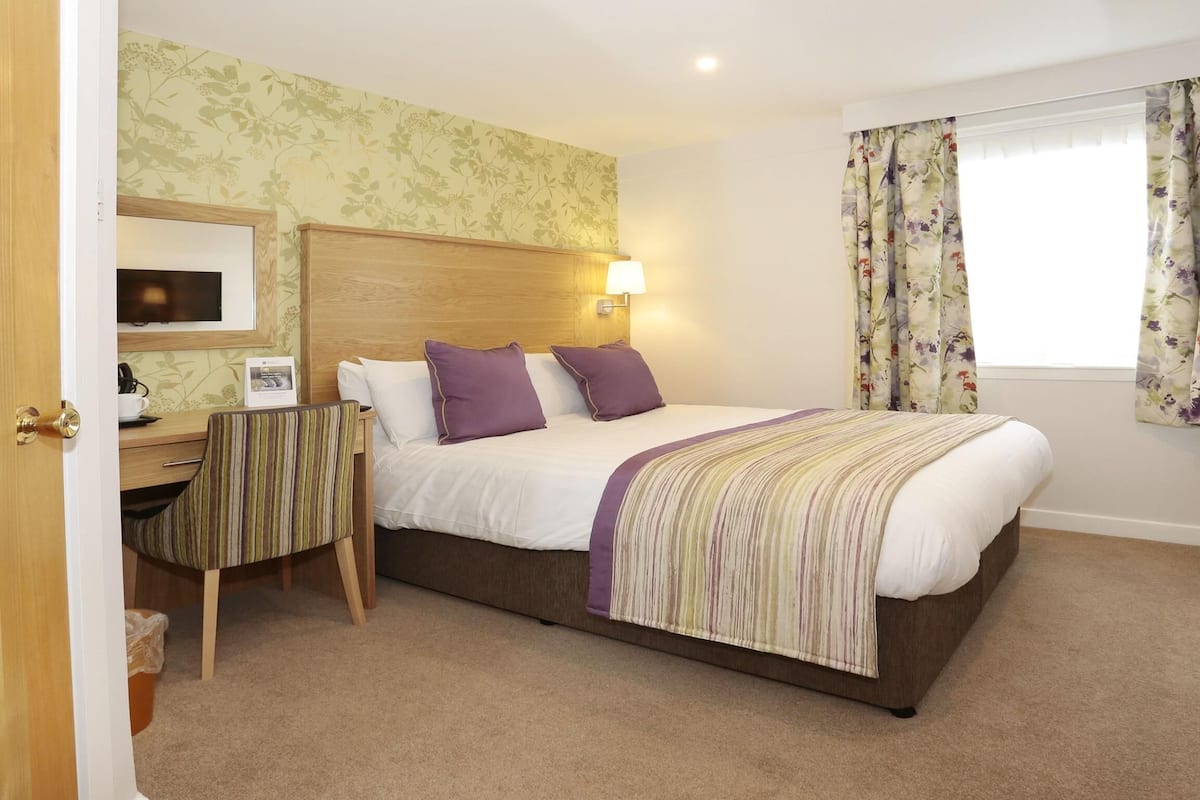 Premium bedding, desk, laptop workspace, iron/ironing board