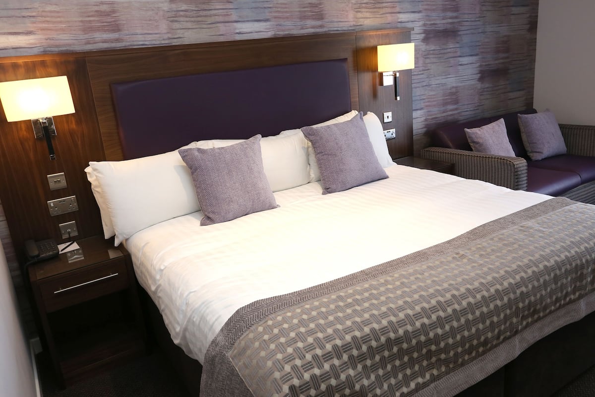 Premium bedding, desk, laptop workspace, iron/ironing board