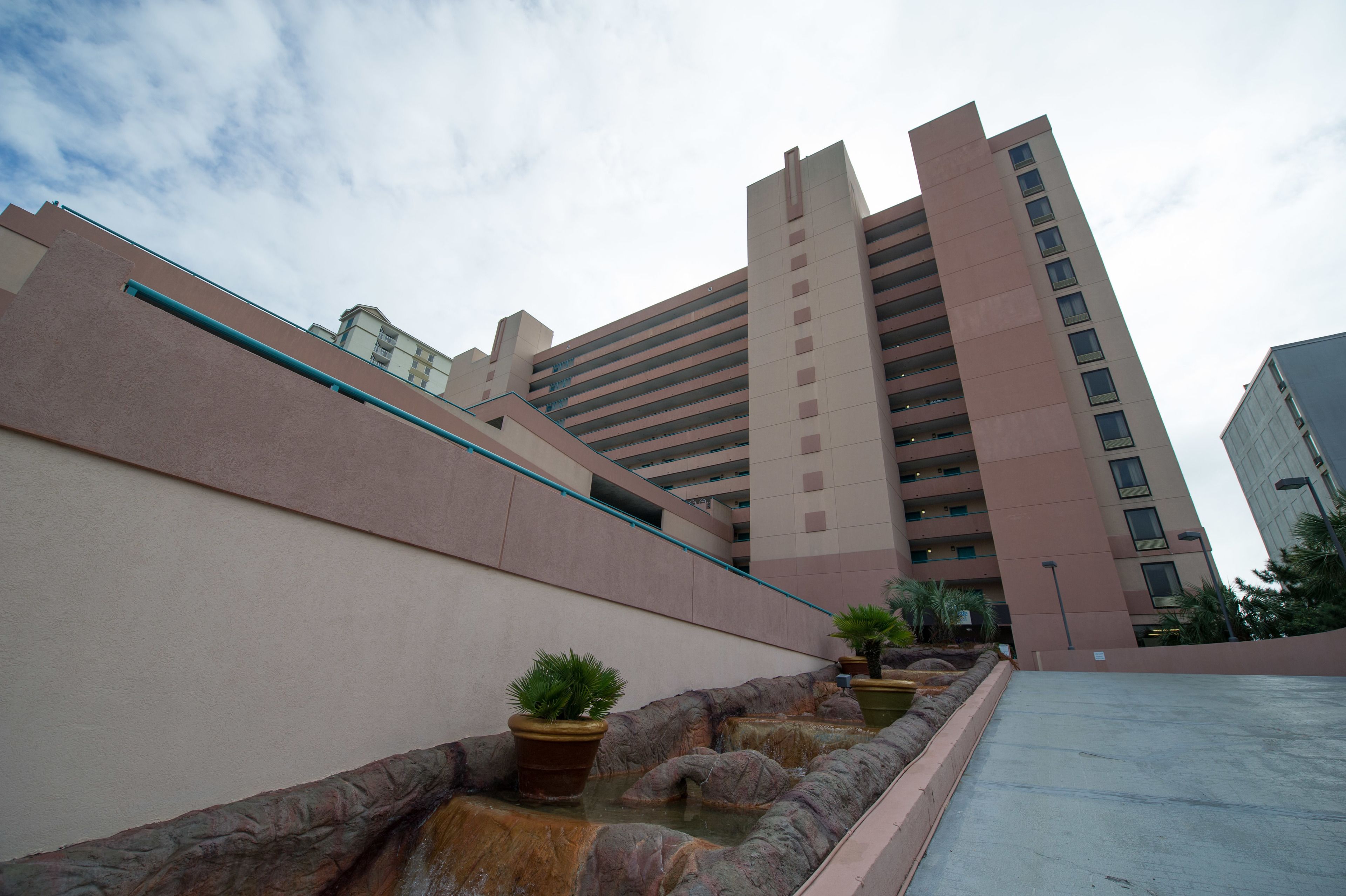 A modern building with a flat roof and a series of balconies.
