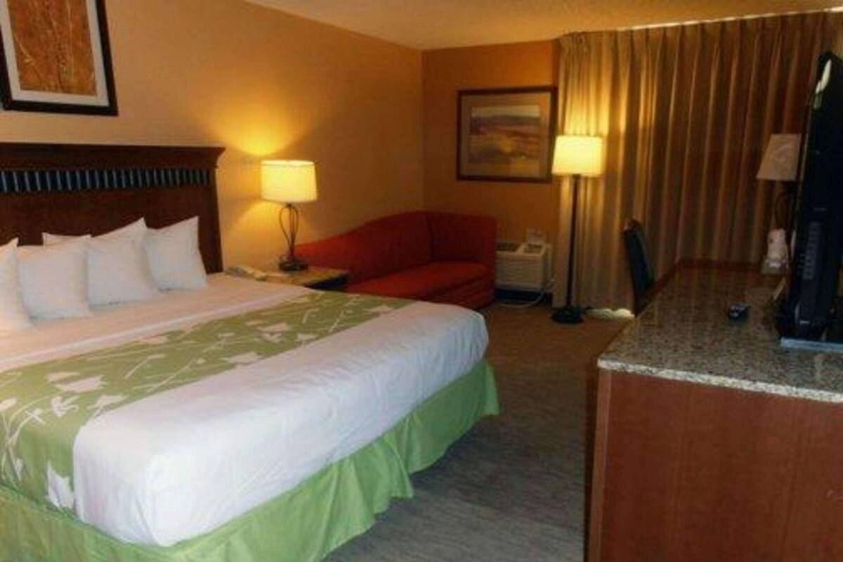 Desk, laptop workspace, blackout drapes, iron/ironing board