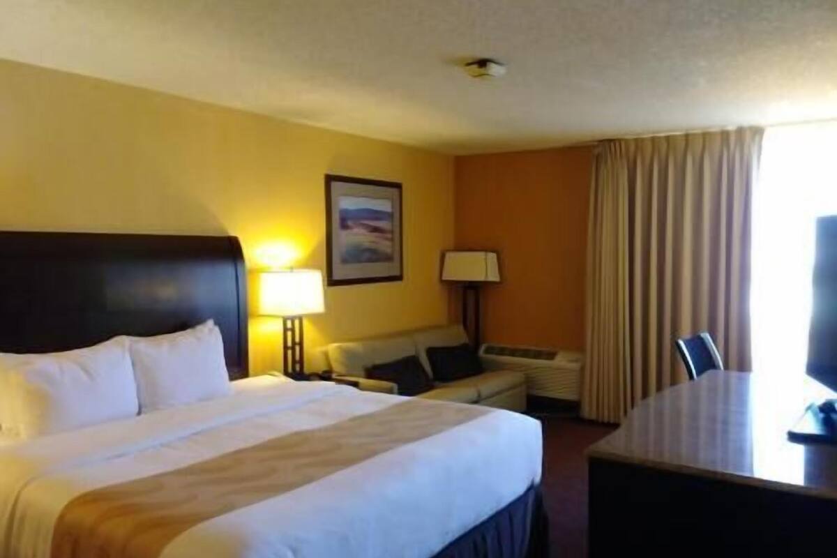 Desk, laptop workspace, blackout drapes, iron/ironing board