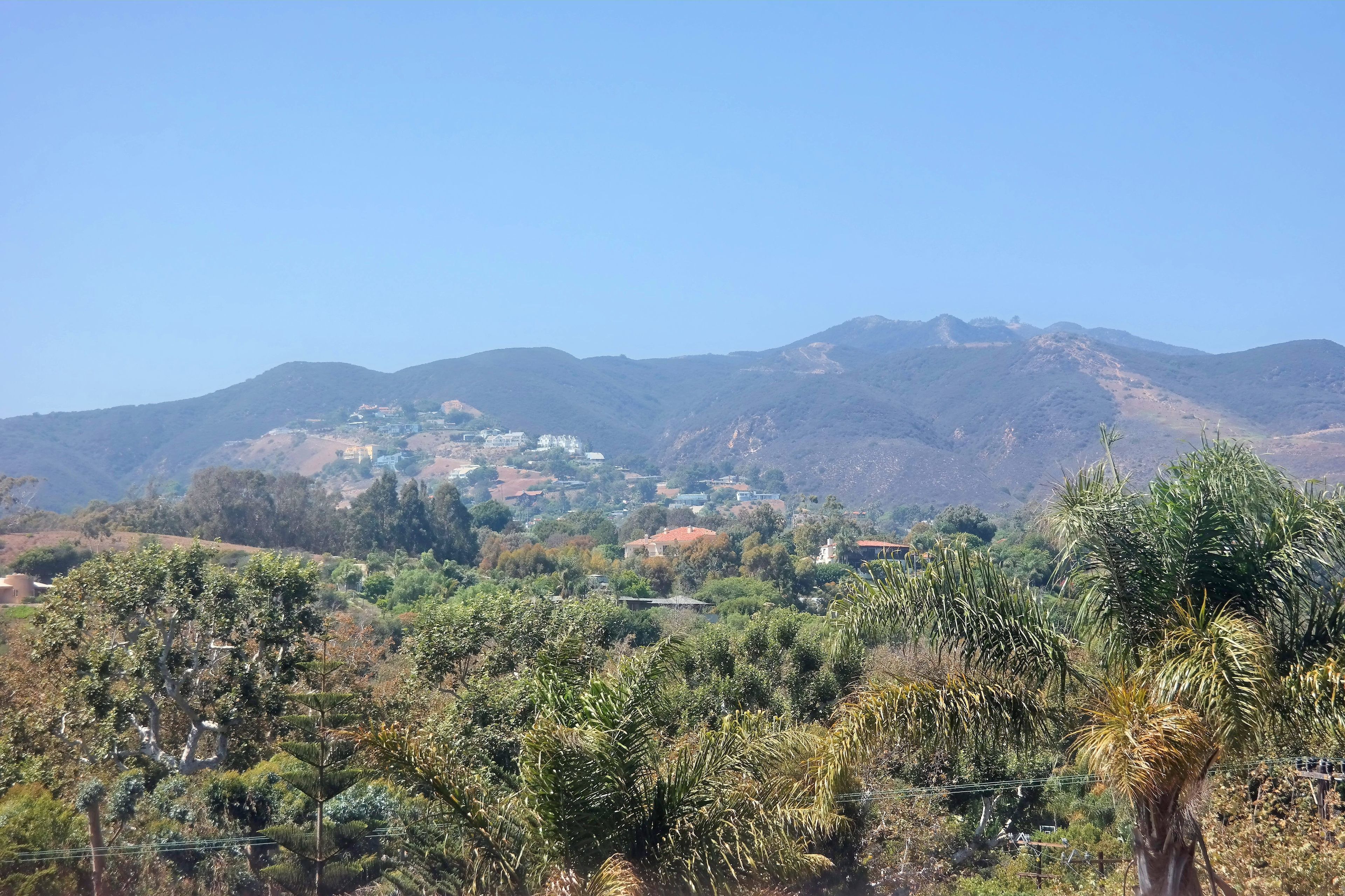 A mountainous landscape with a village nestled among the hills.