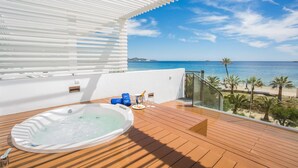 A wooden deck with a hot tub, a glass-enclosed balcony, and a view of the sea. - Grand Palladium White Island Resort & Spa - All Inclusive (Sant Josep de sa Talaia)