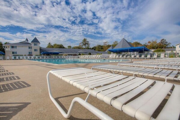 Relax by the resort pool surrounded by lounge chairs and enjoy the view of the surrounding buildings.