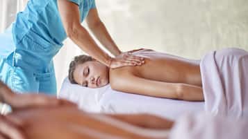 Expert therapists offer soothing massages on a comfortable table.