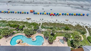 An aerial view of a beach with a swimming pool and lounge chairs. - Island Vista Resort (Myrtle Beach)
