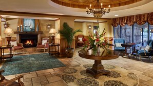 A spacious lobby with a fireplace, comfortable seating, and a chandelier. - Island Vista Resort (Myrtle Beach)