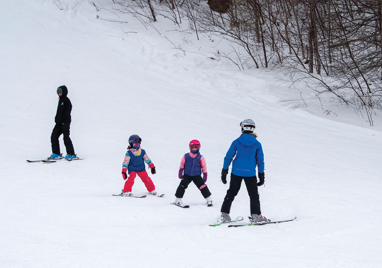 A group of skiers on a snowy slope.