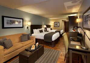 A hotel room with a sofa, a bed, a desk with a laptop, and a chair. - Hockley Valley Resort (Mono)