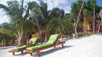 On the beach, white sand, sun-loungers, kayaking