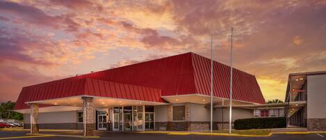 A building with a red roof and a covered entrance area.