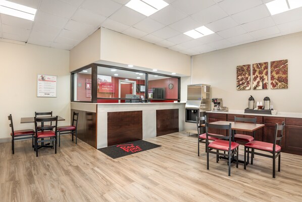 A modern restaurant with a counter, seating area, and a visible menu board. - Red Roof Inn Richmond, VA (Richmond)